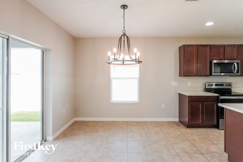 a kitchen with wooden cabinets and a chandelier
