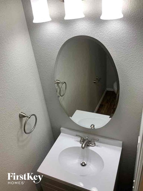a small bathroom with a sink and a mirror