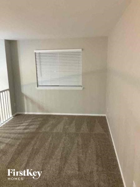A room with a FirstKey Homes logo on the carpet.