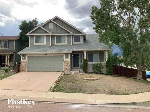 A house with a garage is for sale.