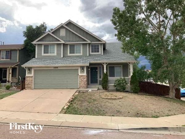 A house with a garage is for sale.