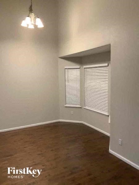 A room with wooden floors and white walls.