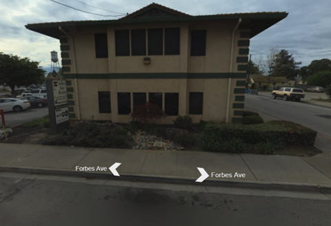 A building with a sign that says Forbes Ave.