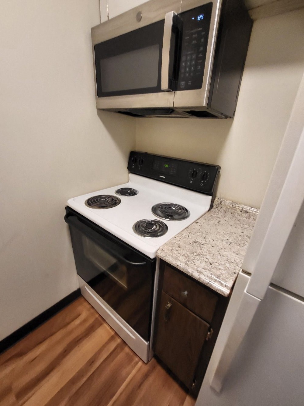 a small kitchen with a stove and a microwave