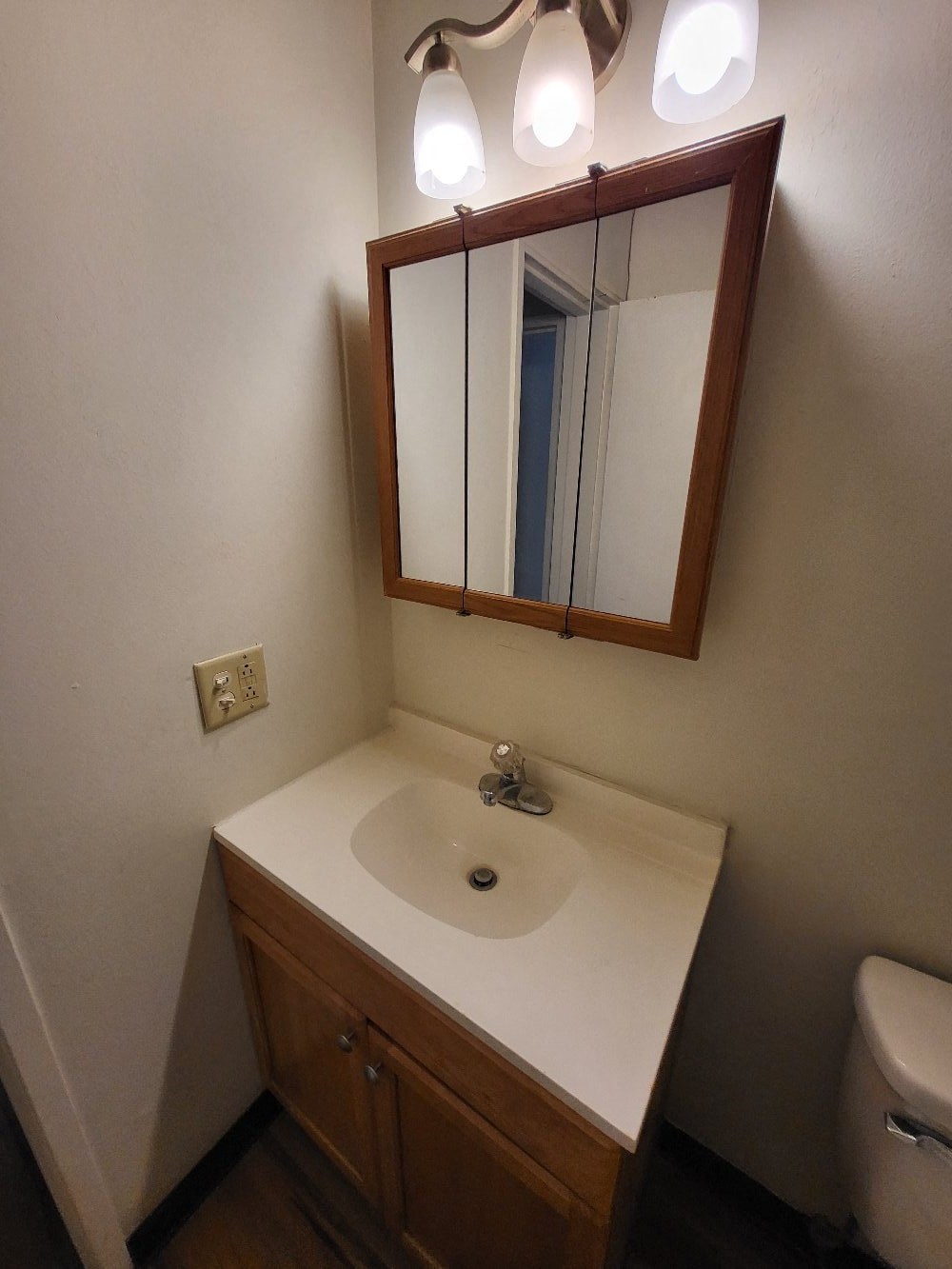 a small bathroom with a sink and a mirror
