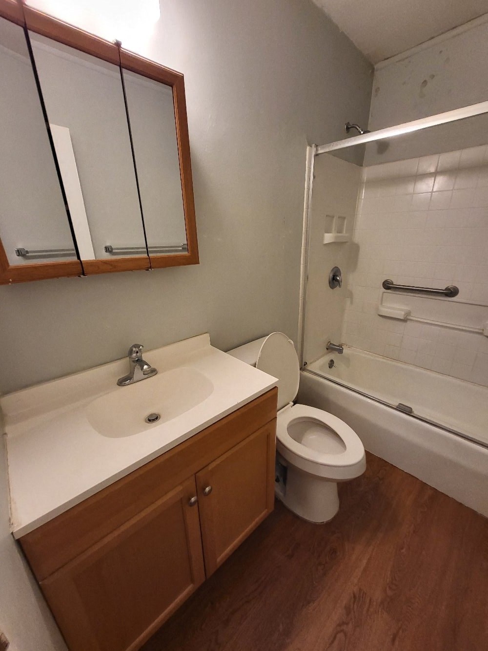 an empty bathroom with a sink toilet and shower