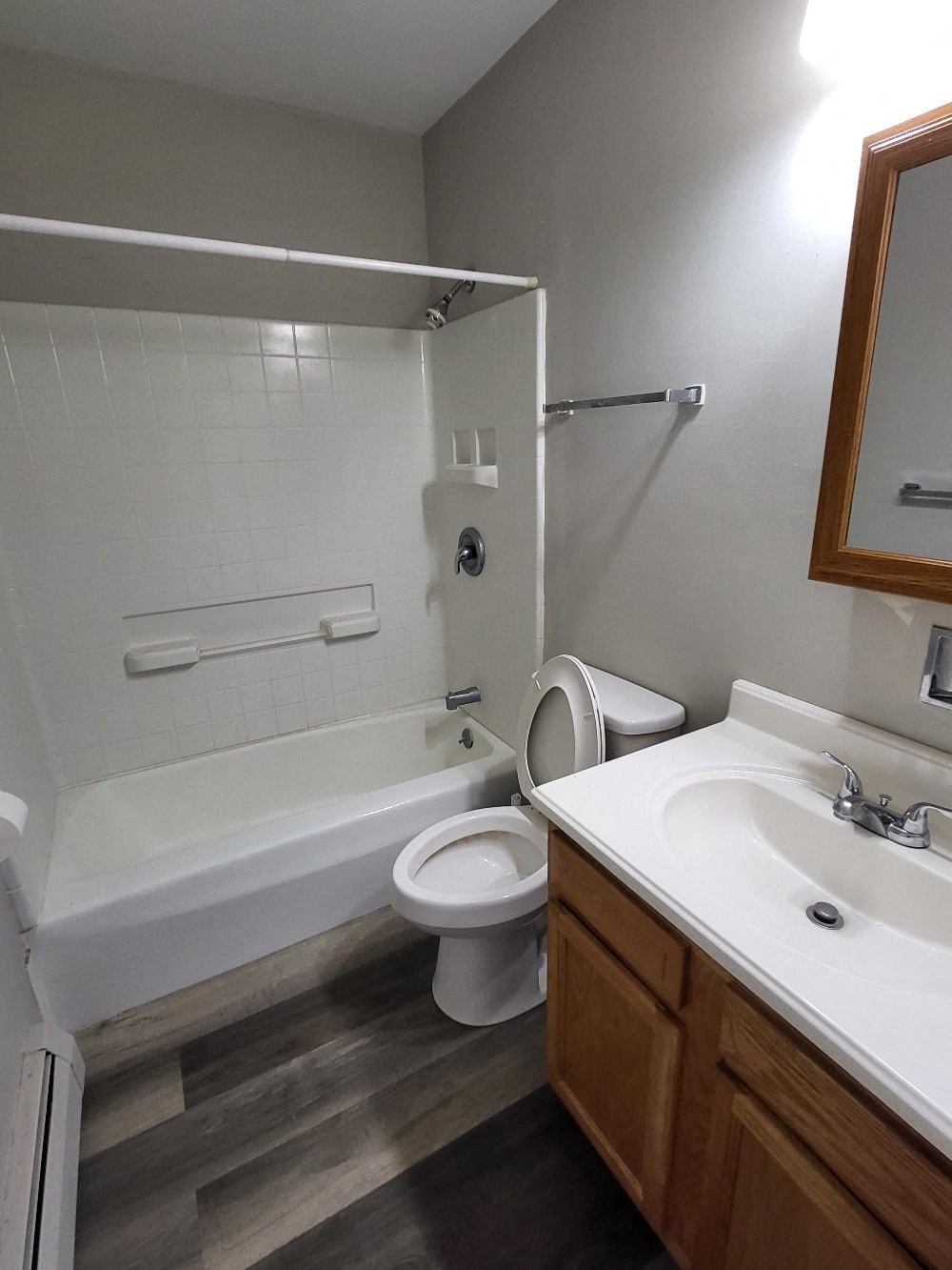 a bathroom with a toilet and a sink and a bath tub