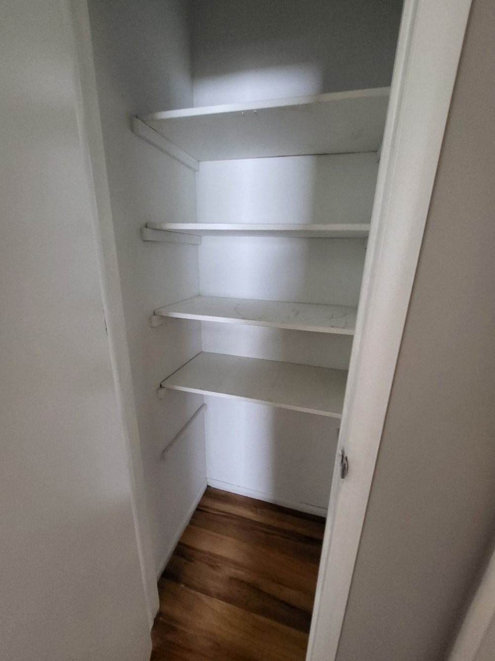 a walk in closet with empty shelves in a closet