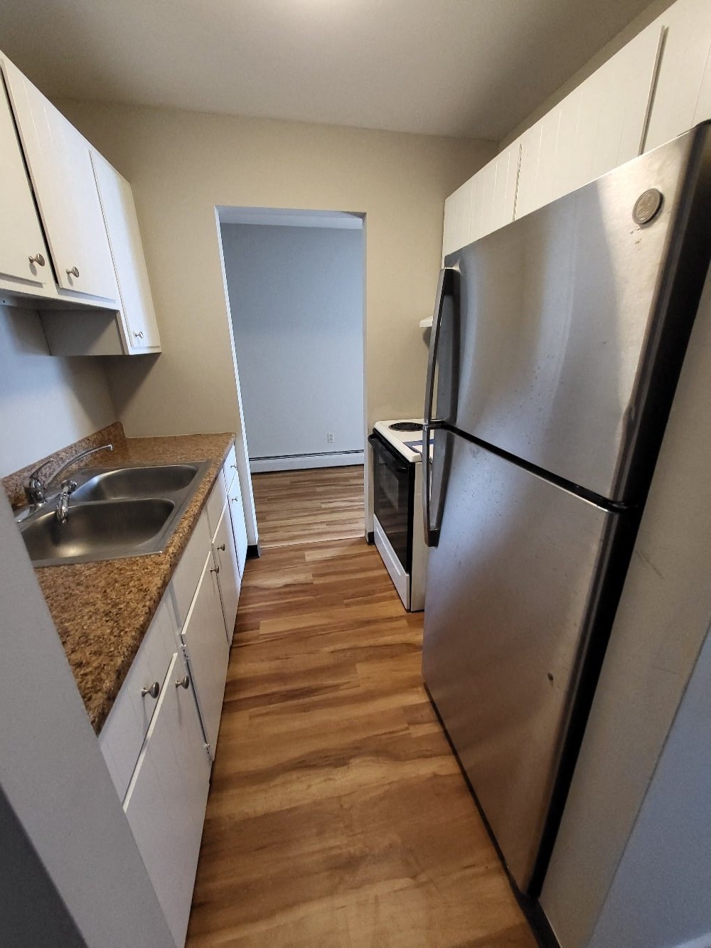 a kitchen with stainless steel appliances and white cabinets