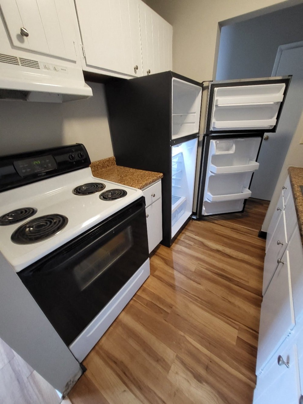 a kitchen with a stove and a refrigerator