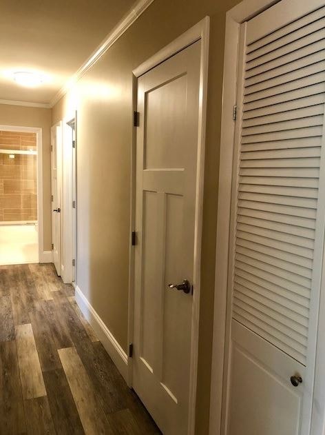 a hallway with a closet and a white door