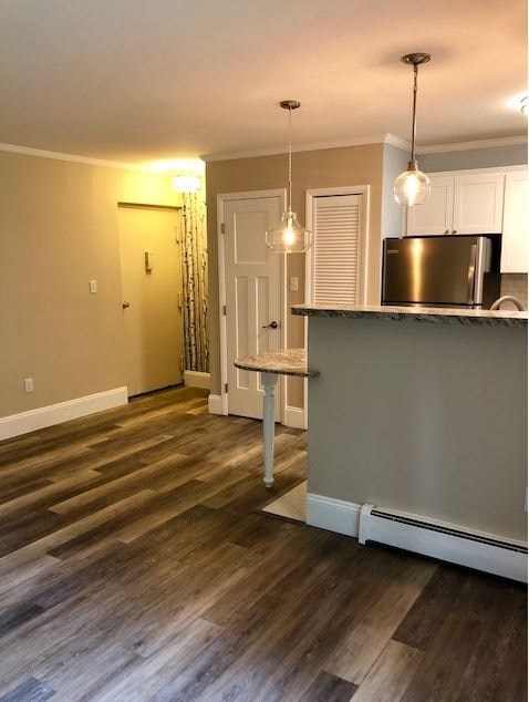 a living room with a kitchen and a table
