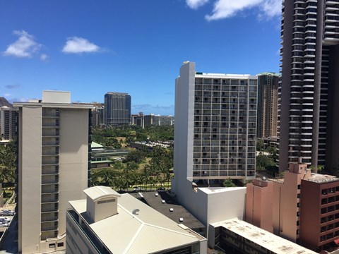 A cityscape with various buildings and a clear blue sky.