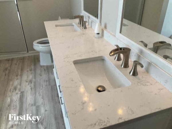 a bathroom with a sink and a toilet and a mirror