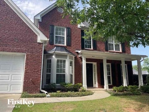 a red brick house with a white garage door