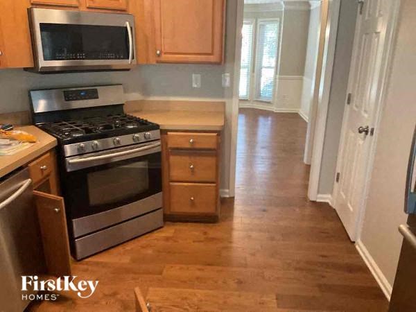 a kitchen with a stove and a microwave