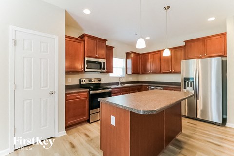 a kitchen with wooden cabinets and stainless steel appliances