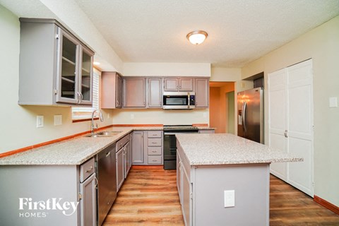 a kitchen with granite counter tops and stainless steel appliances