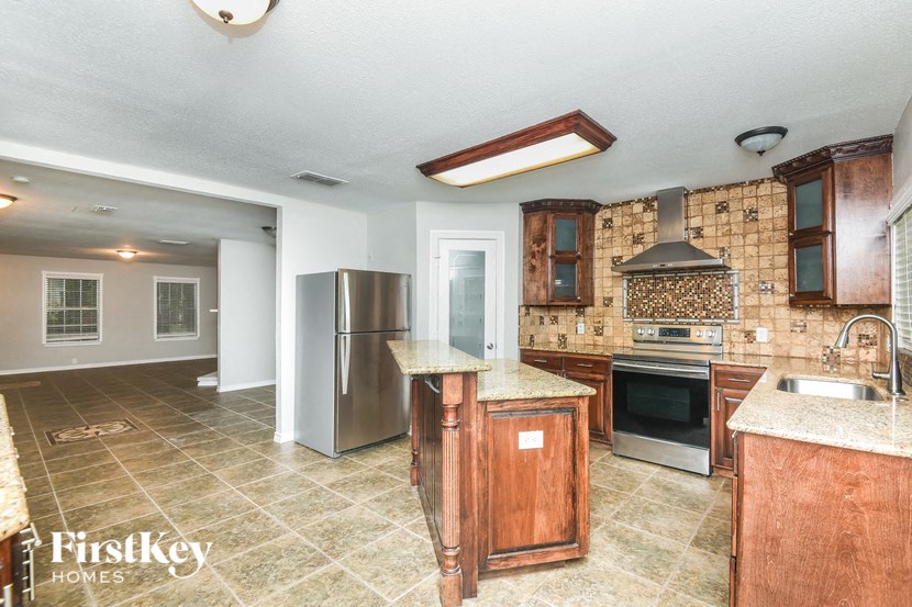 a kitchen with stainless steel appliances and wooden cabinets