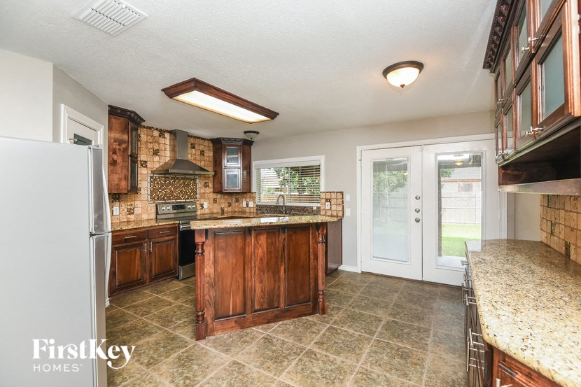 a kitchen with wooden cabinets and a counter top