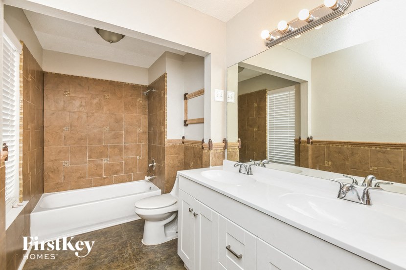 a bathroom with a white sink and a tub and a toilet