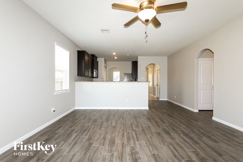 the living room is open to the kitchen and dining room