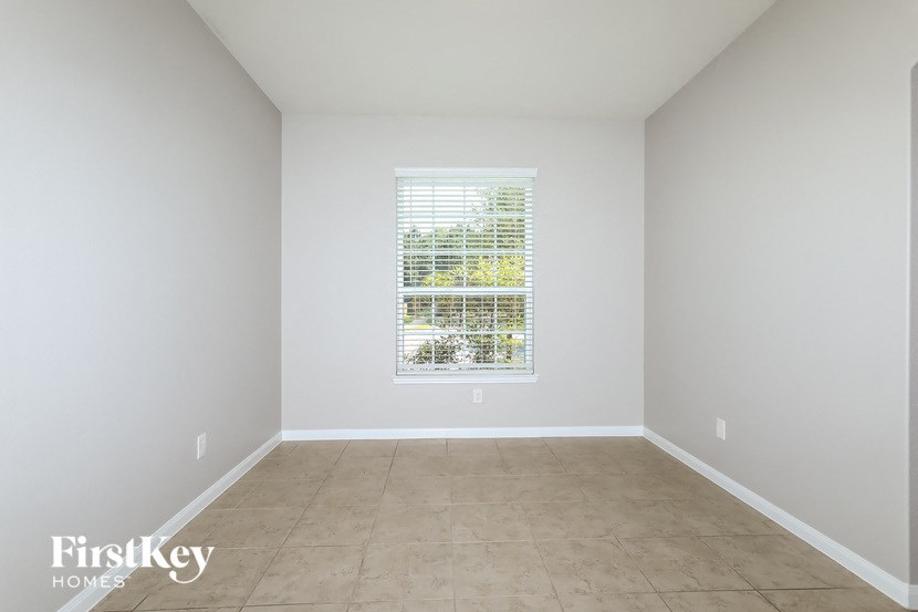 a empty room with a window and a tiled floor