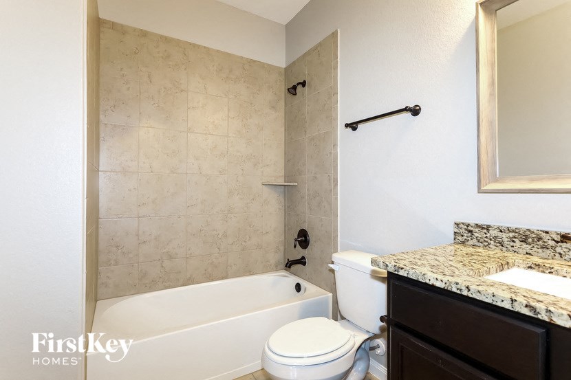a bathroom with a tub and a toilet and a sink
