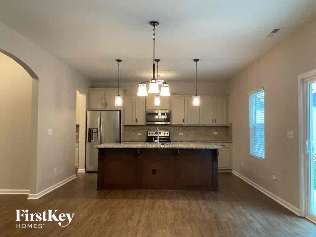 an empty kitchen with an island in the middle