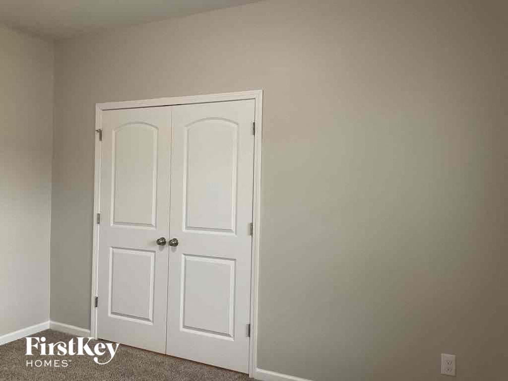 a pair of closet doors in a room with a carpet