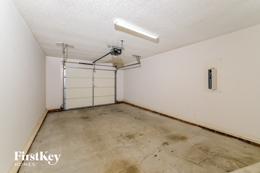 the inside of a garage with a white wall and a garage door