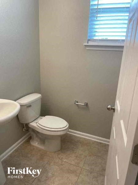 a white bathroom with a toilet and a sink