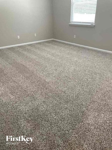 a carpeted floor in a room with a window
