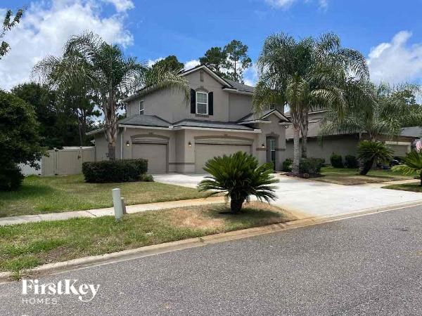 a house with a palm tree in front of it