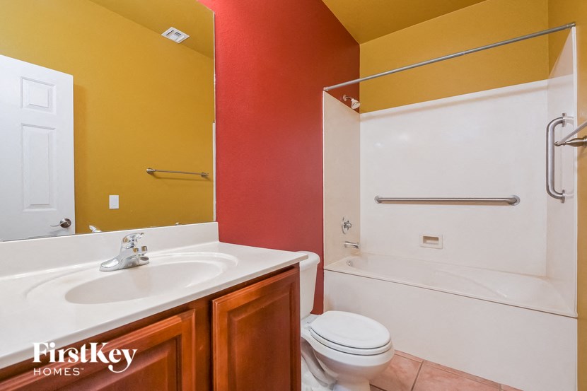 A bathroom with a white sink and toilet.