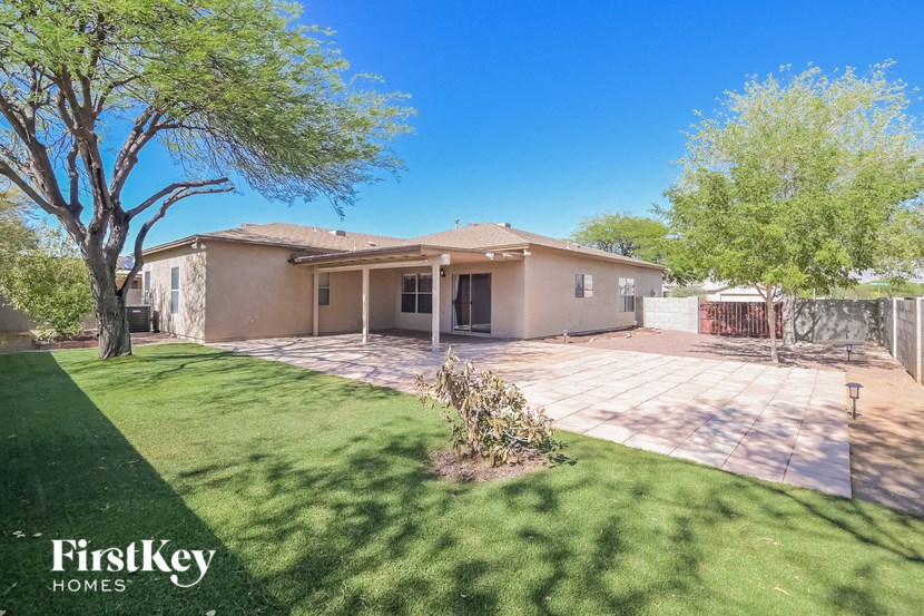 A house with a green lawn and a tree in front of it.