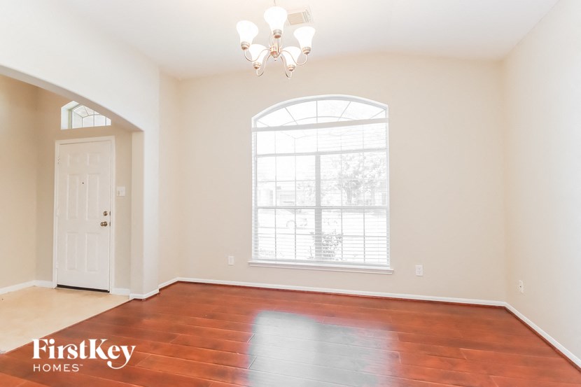 the living room of an empty house with a large window