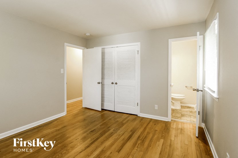 an empty room with a closet and a toilet in it