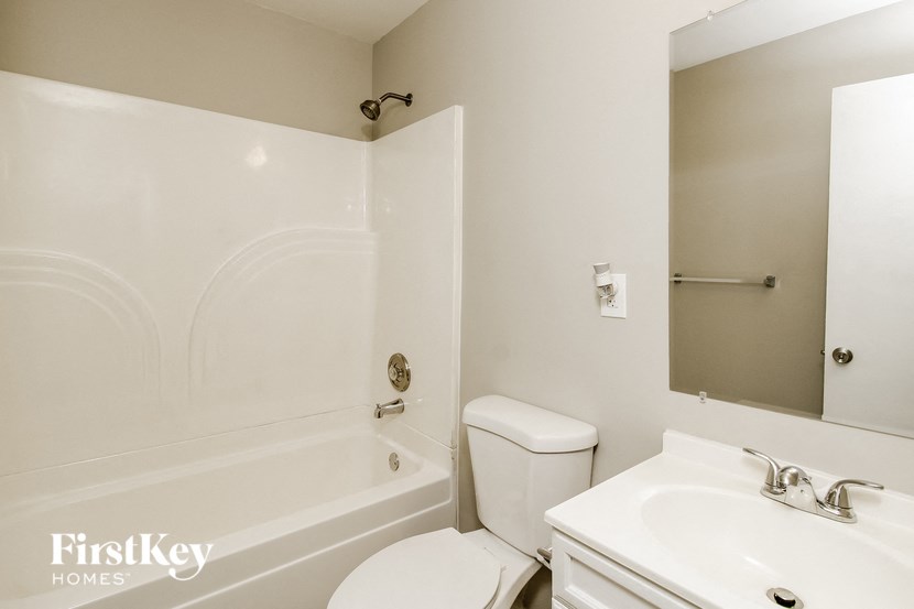a white bathroom with a sink toilet and tub