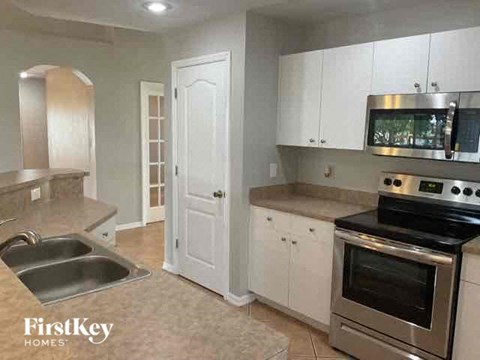a kitchen with stainless steel appliances and white cabinets