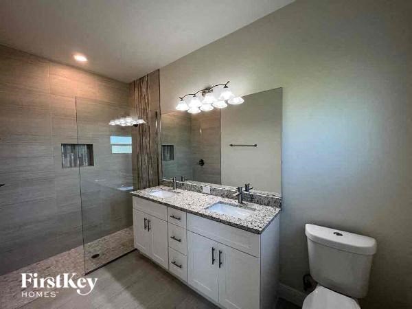 a bathroom with a toilet a sink and a shower