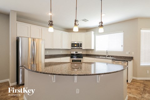 A kitchen with a granite countertop and a FirstKey Homes logo.