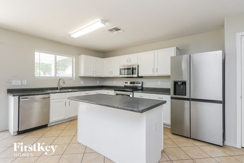 A kitchen with white cabinets and stainless steel appliances.
