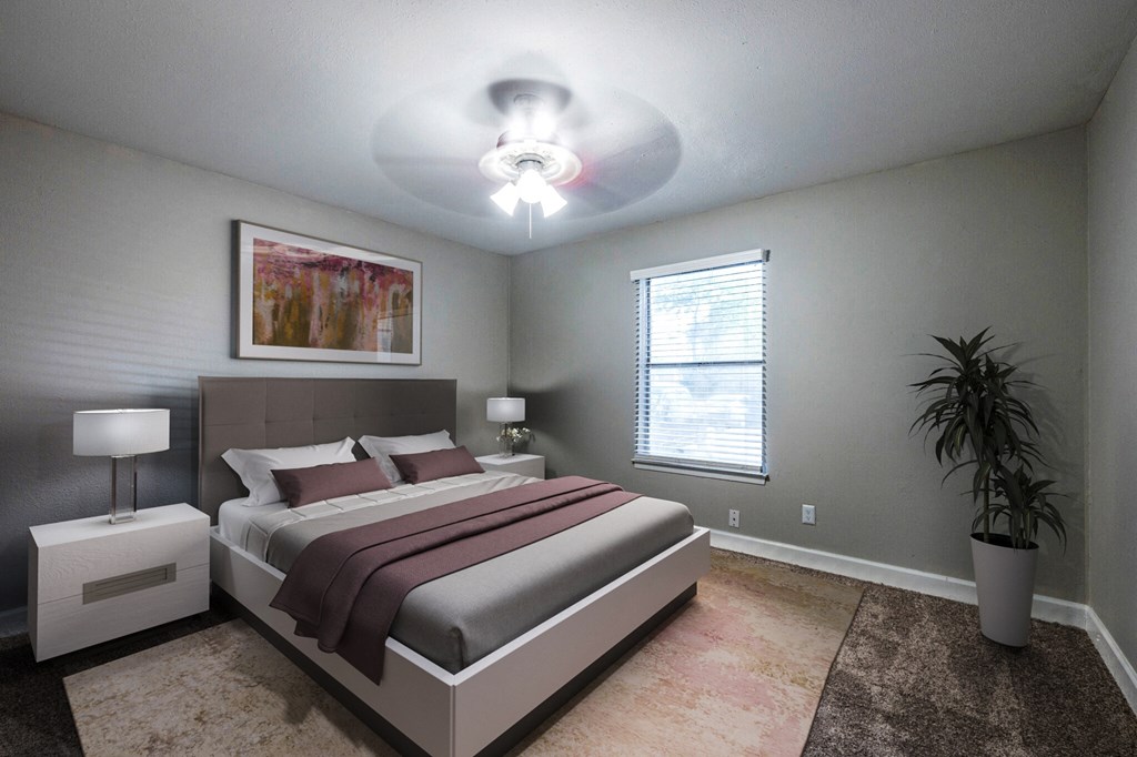 a bedroom with a bed and a ceiling fan