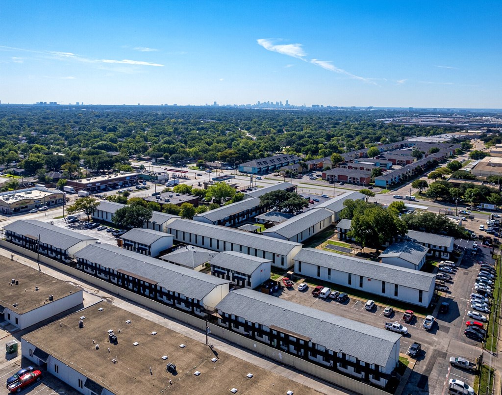 an aerial view of a factory with a city in the background