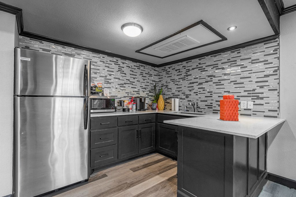 a kitchen with a stainless steel refrigerator and a counter top