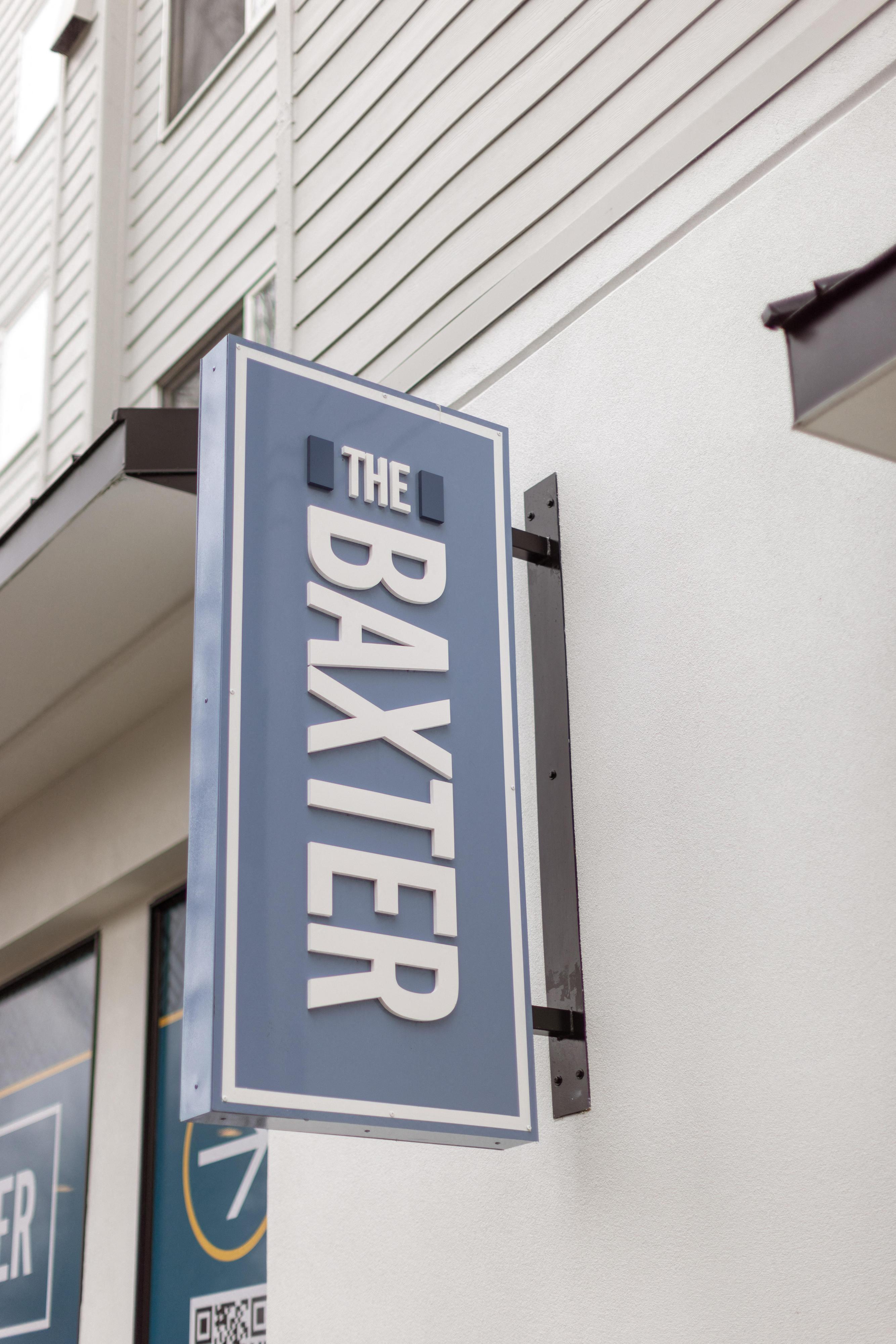 a blue and white sign on the side of a building