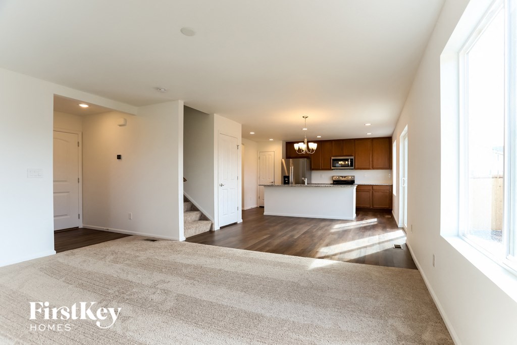 an empty living room and kitchen in a new home