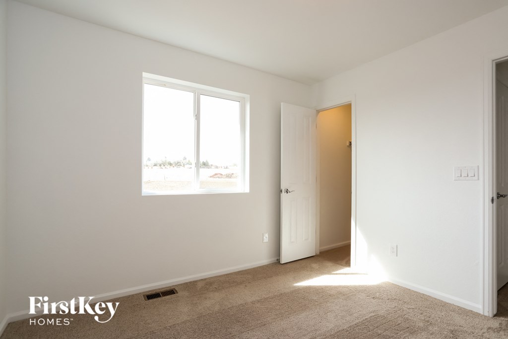 a white room with a window and a door
