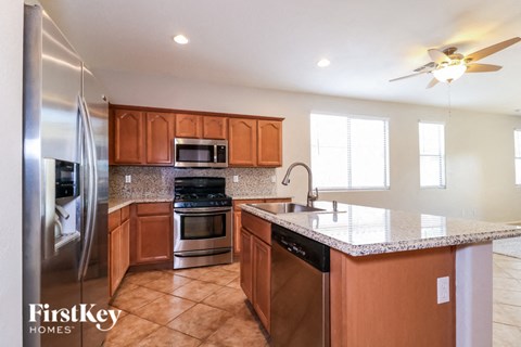 A kitchen with wooden cabinets and a refrigerator.